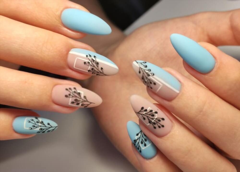 Beautifully manicured hands, featuring blue and pink nails and floral nail art